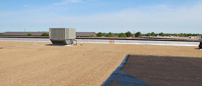 The Purpose of Stone or Gravel Ballast on a Commercial Roof | Roberts  Roofing